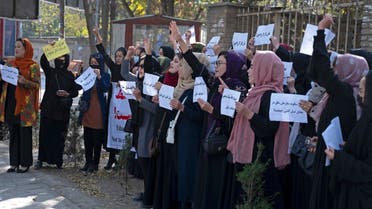 Afghan women hold placards during a protest in front of Kabul University in Kabul on October 18, 2022. (AFP)