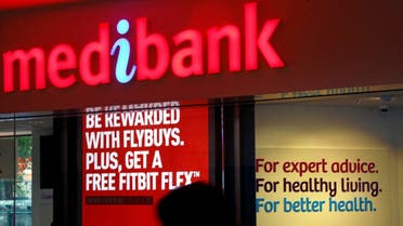 FILE PHOTO: A woman walks past a branch of the Australian health insurer Medibank Private in Sydney October 20, 2014. REUTERS/David Gray/File Photo/File Photo