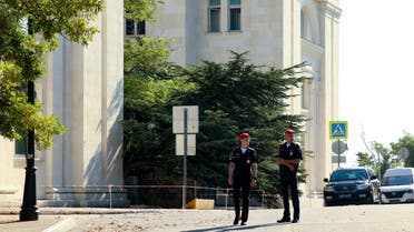 Russian soldiers guard the headquarters of Russia's Black Sea Fleet in Sevastopol, Crimea, Sunday, July 31, 2022. A drone-borne explosive device detonated Sunday at the headquarters of Russia's Black Sea Fleet on Sunday, injuring six people, officials said. (AP Photo)