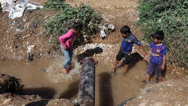 Syrian refugee children play in muddy water in Qab Elias, in Lebanon's Bekaa Valley October 18, 2022. (File photo: Reuters)