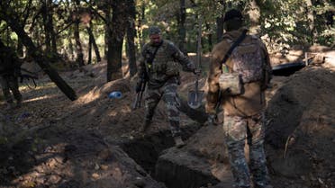 Ukrainian servicemen check the trenches dug by Russian soldiers in a retaken area in Kherson region, Ukraine, Wednesday, Oct. 12, 2022. (AP Photo/Leo Correa)