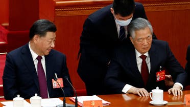 Former Chinese president Hu Jintao is assisted at his seat next to Chinese President Xi Jinping, during the closing ceremony of the 20th National Congress of the Communist Party of China, at the Great Hall of the People in Beijing, China October 22, 2022. (Reuters)