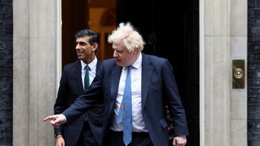 British former Prime Minister Boris Johnson and Chancellor of the Exchequer Rishi Sunak walk out of Downing Street to meet Michelle Ovens of Small Business Saturday, in London, Britain, December 1, 2021. (File photo: Reuters)