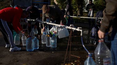 Local people fill up bottles with fresh drinking water, as the main supply pipeline for drinking water for the city was damaged in the Kherson region at the beginning of Russia's attack on Ukraine, in Mykolaiv, Ukraine October 20, 2022. (Reuters)