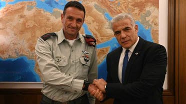 Israeli defense minister Yair Lapid shakes hands with the country's next military chief Major General Herzi Halevi. (Twitter)