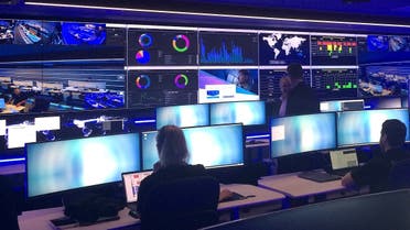 Employees can be seen in the Security Operation Centre for Telstra, Australia's biggest telecoms firm, which is used to monitor, detect and respond to security incidents, including cyber attacks, during a media event in central Sydney, Australia. (Reuters)