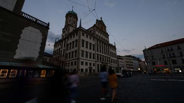 People walk near the unlit town hall, in Augsburg, Germany, July 21, 2022. (File photo: Reuters)