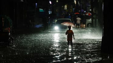 A boy wades through water as streets are flooded due to continuous rain, before the Cyclone Sitrang hits the country in Dhaka, Bangladesh, October 24, 2022. (Reuters)