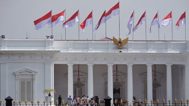 MotoGP riders walk into the Presidential Palace to meet Indonesian President Joko Widodo before taking part in a motorcycle parade in downtown Jakarta on March 16, 2022, ahead of this weekend's MotoGP Indonesia Grand Prix. (AFP)