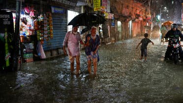 People wade through a flooded street amid continuous rain before the Cyclone Sitrang hits the country in Dhaka, Bangladesh, October 24, 2022. (Reuters)