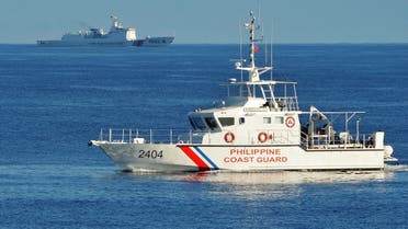  This file photo taken on May 14, 2019 shows a Philippines' coast guard ship (R) sailing past a Chinese coast guard ship during a joint search and rescue exercise between the Philippines and US coast guards near Scarborough Shoal in the South China Sea. (AFP)