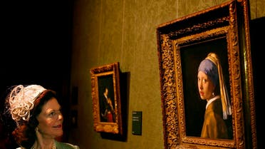 Sweden's Queen Silvia looks at the painting The Girl with the Pearl Earring by Johannes Vermeer during a tour through the Maurits House Museum in The Hague April 22, 2009.  (Reuters)