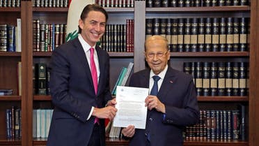 A handout picture provided by the Lebanese photo agency Dalati and Nohra shows Lebanon’s President Michel Aoun (R) posing with US mediator Amos Hochstein at the presidential palace of Baabda, east of the Lebanese capital Beirut on October 27, 2022 with the maritime border agreement that Lebanon and Israel were to sign today. (Dalati and Nohra/AFP)