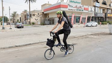Briton Dan Hodd, 29 years old, who left Spain about a month ago to go to the COP27 in Sharm el Sheikh without flying, but mostly biking and using public transportation, rides his bike in Baghdad Iraq October 26, 2022. (Reuters)