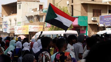 Sudanese anti-coup demonstrators march in a street in Khartoum Bahri north of the Sudanese capital on October 30, 2022. (AFP)