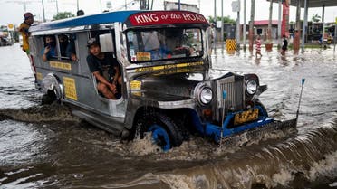 A jeepney wades through a flooded road following heavy rains brought by Tropical Storm Nalgae, in Las Pinas City, Metro Manila, Philippines, October 30, 2022. REUTERS/Lisa Marie David
