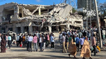 Civilians gather near the ruins of a building at the scene of an explosion along K5 street in Mogadishu, Somalia October 30, 2022. (Reuters)