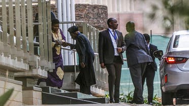 Member of the African Union mediation team, Former Nigerian President Olusegun Obasanjo (2ndL) is greeted as he arrives for the peace talks between the Ethiopian government and Tigrayan People's Liberation Front (TPLF) held at the Department of International Relations and Cooperation (DIRCO) headquarters in Pretoria on October 26, 2022. The first formal peace talks between the warring sides in the brutal two-year conflict in Ethiopia's Tigray region opened in South Africa on Tuesday. Led by the African Union (AU), the negotiations in Pretoria follow a fierce surge in fighting in recent weeks that has alarmed the international community and triggered fears for civilians caught in the crossfire. (Photo by Phill Magakoe / AFP)