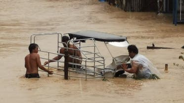 People wade through flood water due to tropical storm Nalgae in Boac, Marinduque, Philippines October 29, 2022 in this picture obtained from social media. Alex Fellizar/via REUTERS THIS IMAGE HAS BEEN SUPPLIED BY A THIRD PARTY. MANDATORY CREDIT. NO RESALES. NO ARCHIVES. REFILE - QUALITY REPEAT