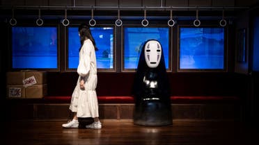 A member of the media looks at an exhibit at Ghibli's Grand Warehouse during a media tour of the new Ghibli Park in Nagakute, Aichi prefecture on October 12, 2022. (AFP)