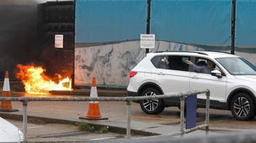 A man throws an object out of a car window next to the Border Force centre after a firebomb attack in Dover. (Reuters)