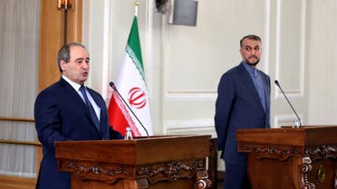 Syrian Foreign Minister Faisal Meqdad (L) speaks as his Iranian counterpart Hossein Amir-Abdollahian (R) looks on during press conference in the Iranian capital Tehran, on December 6, 2021. (File photo: AFP)