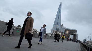 Workers cross London Bridge, with The Shard skyscraper seen behind, during the morning rush-hour, during the COVID-19 lockdown as the British government encouraged working from home, in the City of London financial district, London, Britain. (Reuters)