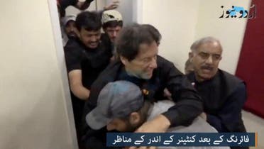 Former Pakistani Prime Minister Imran Khan is helped after he was shot in the shin in Wazirabad, Pakistan, on November 3, 2022 in this still image obtained from video. (Reuters)