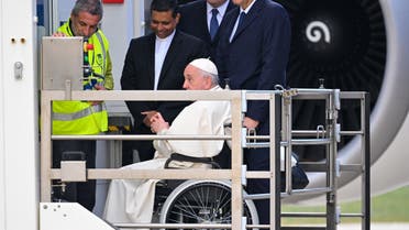 Pope Francis, seated on a wheelchair (C), is lifted on a platform to board a plane on November 3, 2022 at Rome's Fiumicino airport, prior to depart for a four-day trip to Bahrain. (AFP)