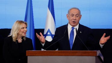 Likud party leader Benjamin Netanyahu, accompanied by wife Sara Netanyahu, addresses his supporters at his party headquarters during Israel's general election in Jerusalem, November 2, 2022. REUTERS/Ammar Awad/File Photo