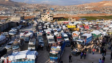 Trucks full of Syrian refugees belongings, wait at a gathering point to cross the border back home to Syria, in the eastern Lebanese border town of Arsal, Lebanon, Wednesday, Oct. 26, 2022. Several hundred Syrian refugees boarded a convoy of trucks laden with mattresses, water and fuel tanks, bicycles – and, in one case, a goat – Wednesday morning in the remote Lebanese mountain town of Arsal in preparation to return back across the nearby border.(AP Photo/Hussein Malla)