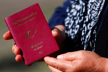 A voter holding her Turkish passport 