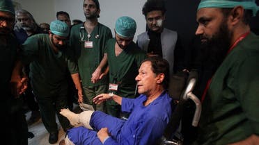 Former Pakistan's Prime Minister Imran Khan sits in a wheelchair after he was wounded following a shooting incident during a long march in Wazirabad, at the Shaukat Khanum Memorial Cancer Hospital & Research Centre in Lahore, Pakistan November 4, 2022. REUTERS/Mohsin Raza