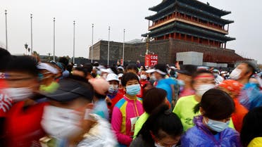 Participants wait at the Tiananmen Square before the Beijing Marathon, the first in two years after being cancelled in 2020 and 2021 because of the coronavirus disease (COVID-19), in Beijing, China November 6, 2022. (Reuters)