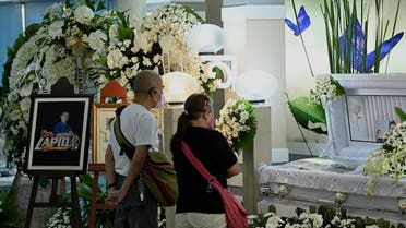 People pay their respects at the wake of journalist Percival Mabasa in Paranaque, Metro Manila on October 6, 2022. Mabasa, a Philippine radio broadcaster, was shot dead near his home in suburban Manila, police said on October 4, the latest in a long list of journalists killed in the country. (Photo by JAM STA ROSA / AFP)