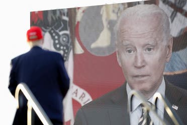 Trump speaking from Miami yesterday, with a large picture of Biden next to him (Reuters)