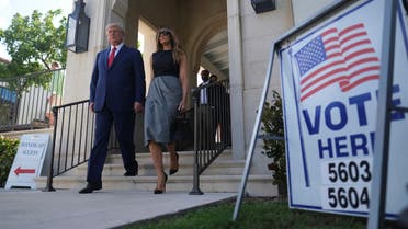 Former U.S. President Donald Trump and his wife Melania walk outside a polling station during midterm election in Palm Beach, Florida, U.S. November 8, 2022. REUTERS/Ricardo Arduengo