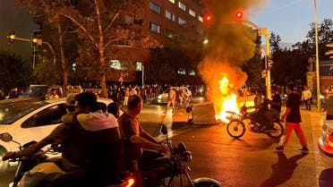 A police motorcycle burns during a protest over the death of Mahsa Amini, a woman who died after being arrested by the Islamic republic’s “morality police,” in Tehran, Iran, on September 19, 2022. (Reuters)
