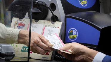 A customer purchases a ticket for the Powerball jackpot of $1.9 billion dollars at a newsstand in New York City, US, November 7, 2022. (Reuters)