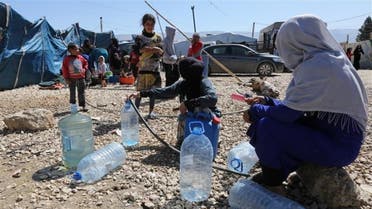 Syrian refugees fill containers and bottles with water at a makeshift settlement in Bar Elias town, in the Bekaa valley, Lebanon March 28, 2017. (Reuters)