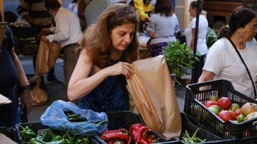 Customer picks her vegetables at Souk el Mawsam market in Beirut, October 25, 2022. (Reuters)
