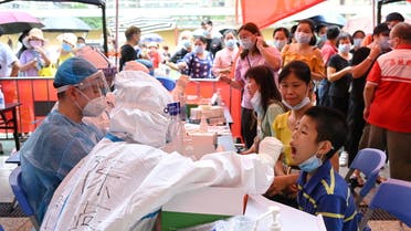 A medical worker collects a swab from a resident during a mass testing for the coronavirus disease (COVID-19) at a makeshift testing site at a stadium in Guangzhou, Guangdong province, China May 30, 2021. (File photo: Reuters)