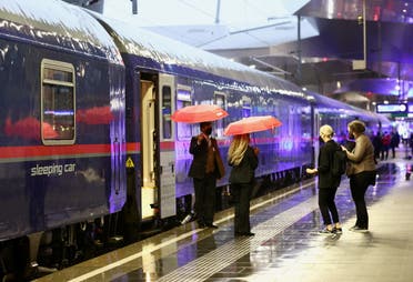 Passengers wait on the platform before boarding a Nightjet train of Austrian Federal Railways OeBB ahead of departure as it resumes travel operation amid the coronavirus disease (COVID-19) outbreak, at the main station in Vienna, Austria, May 24,2021. (Reuters)
