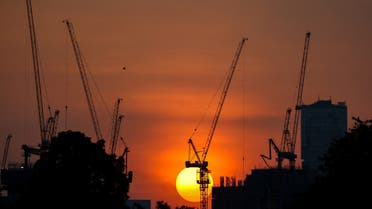 The sun sets behind a construction crane in Bangkok, Thailand, November 8, 2022. (Reuters)