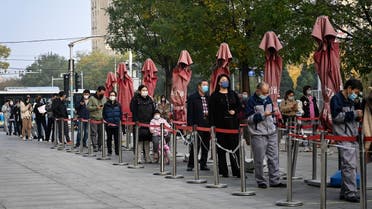 People wait in line to be tested for COVID-19 coronavirus at a nucleic acid testing station in Beijing on November 10, 2022. (AFP)