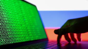 Illustration shows laptop with binary code on the screen in front of Russian flag. (Reuters)