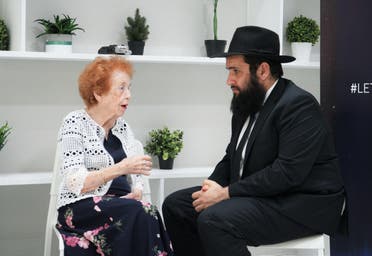 Holocaust survivor Eve Kugler speaks with Rabbi Levi Duchman in Dubai. (Marco Ferrari/Al Arabiya English)