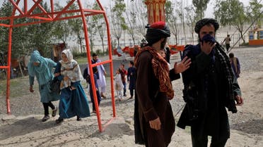 Taliban fighters walk as they take a day off to visit the amusement park at Kabul's Qargha lake on the outskirts of Kabul, Afghanistan, July 29, 2022. (File photo: Reuters)
