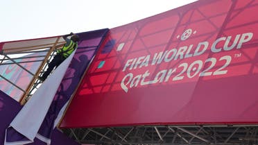 A worker fixes banners at Souq Waqif, which has been decorated ahead of the FIFA World Cup 2022 soccer tournament in Doha, Qatar November 11, 2022. (Reuters)