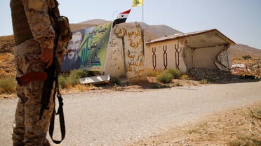 A Hezbollah fighter stands as he holds his weapon in Western Qalamoun, Syria August 23, 2017. REUTERS/Omar Sanadiki